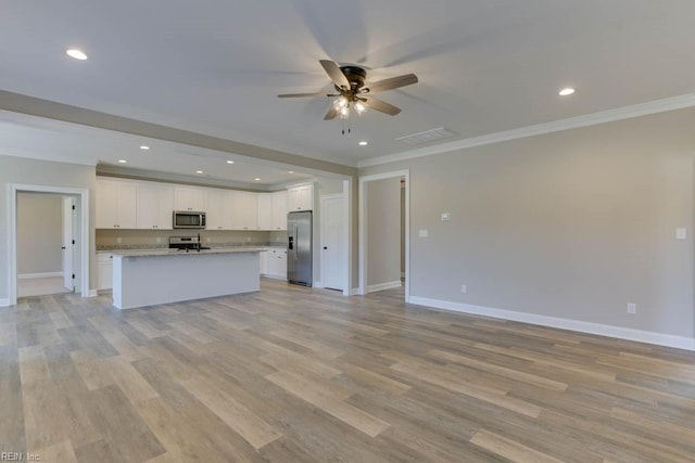 kitchen featuring white cabinetry, an island with sink, ornamental molding, and appliances with stainless steel finishes