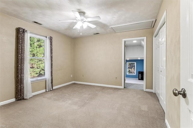 carpeted spare room with ceiling fan