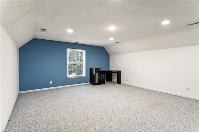 bonus room featuring carpet flooring, a textured ceiling, and lofted ceiling