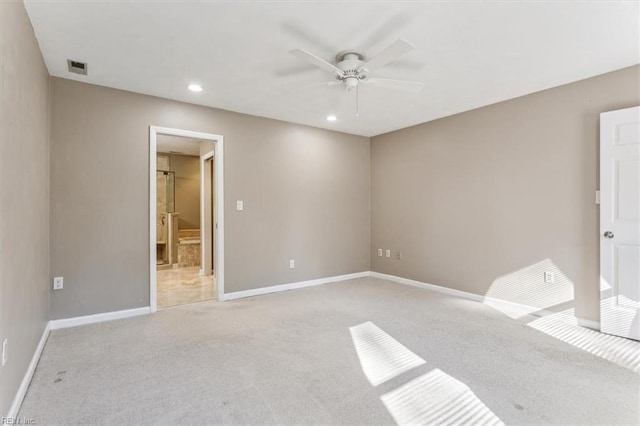 unfurnished bedroom featuring connected bathroom, ceiling fan, and light colored carpet