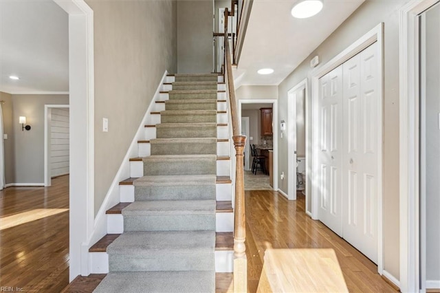 stairway with hardwood / wood-style floors