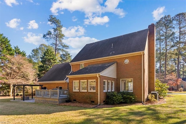 back of property with a lawn and a wooden deck