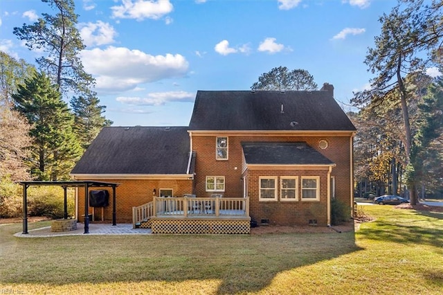 back of property featuring a wooden deck, a patio area, and a yard