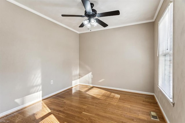 empty room featuring ceiling fan, wood-type flooring, and crown molding