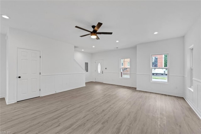 unfurnished living room with light hardwood / wood-style floors and ceiling fan