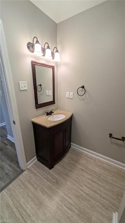 bathroom with vanity and hardwood / wood-style flooring