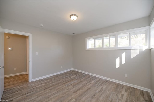 unfurnished room with light hardwood / wood-style floors