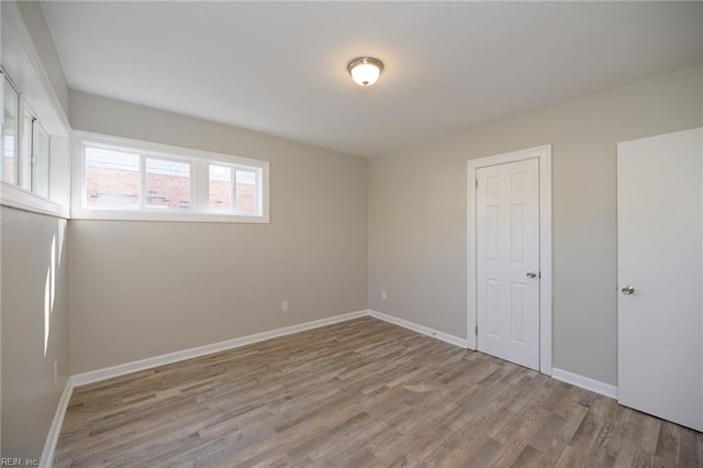 spare room with light hardwood / wood-style flooring