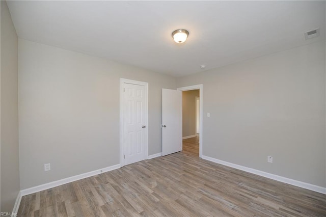 unfurnished room with light wood-type flooring