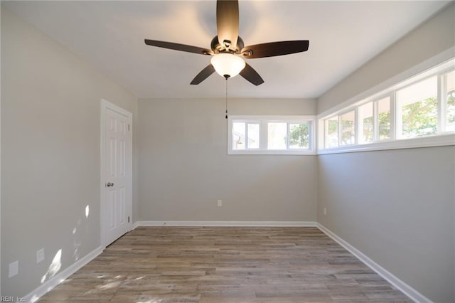 unfurnished room with ceiling fan and wood-type flooring