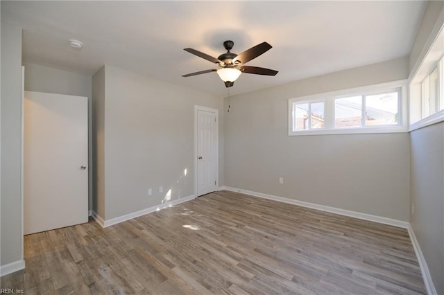 empty room featuring ceiling fan and light hardwood / wood-style flooring