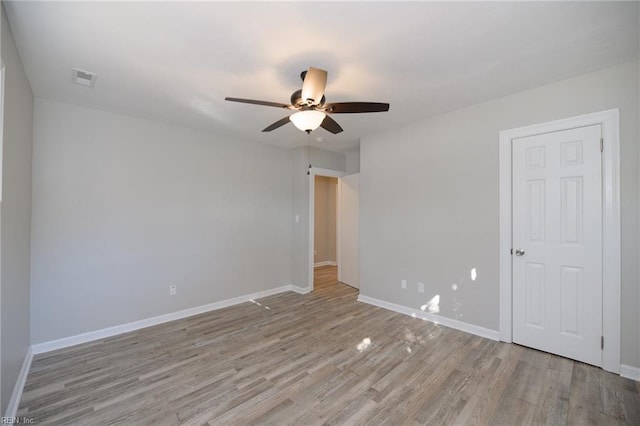 unfurnished room with ceiling fan and light hardwood / wood-style flooring