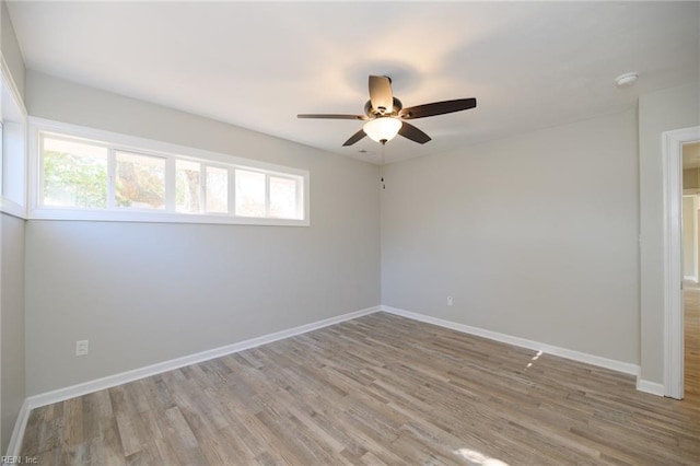 unfurnished room with plenty of natural light, ceiling fan, and light hardwood / wood-style flooring