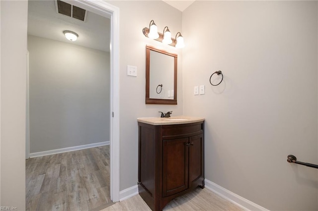 bathroom featuring vanity and wood-type flooring