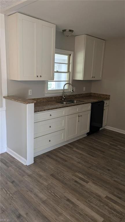 kitchen with white cabinets, dark hardwood / wood-style flooring, black dishwasher, and sink