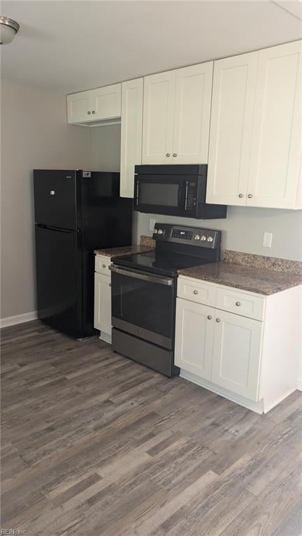 kitchen with black appliances, dark hardwood / wood-style flooring, and white cabinetry