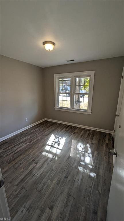 empty room with dark hardwood / wood-style floors