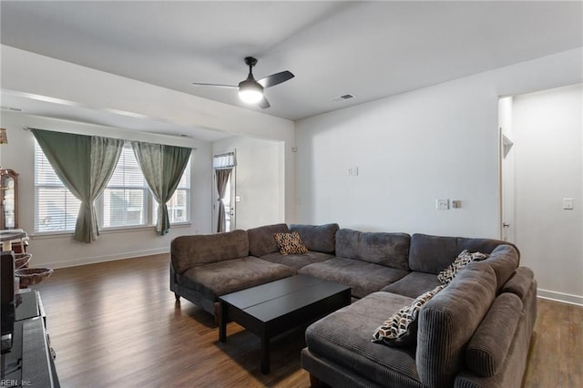 living room featuring dark hardwood / wood-style floors and ceiling fan