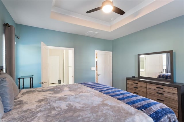 bedroom featuring a tray ceiling and ceiling fan