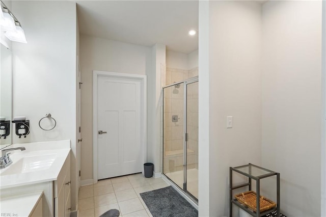 bathroom featuring tile patterned flooring, vanity, and a shower with shower door