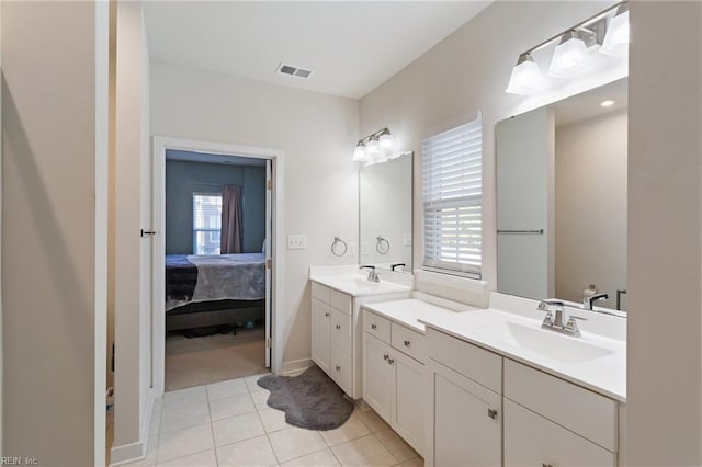 bathroom with tile patterned flooring, vanity, and a wealth of natural light