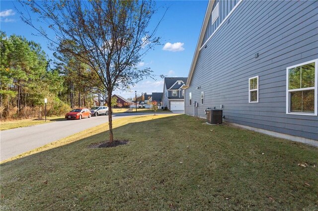 view of yard with cooling unit and a garage