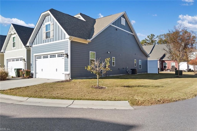 view of side of home with a garage, central AC unit, and a lawn