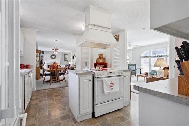 kitchen featuring hanging light fixtures, white stove, white cabinetry, and ceiling fan