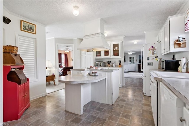 kitchen with a textured ceiling, white appliances, white cabinetry, and sink