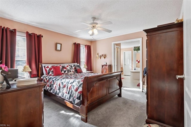 carpeted bedroom featuring ensuite bath, ceiling fan, and a textured ceiling