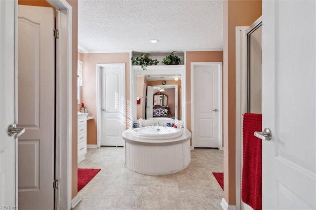 bathroom with vanity, separate shower and tub, and a textured ceiling