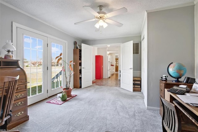 office space with a textured ceiling, light colored carpet, ceiling fan, and ornamental molding