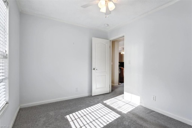 carpeted empty room featuring ceiling fan