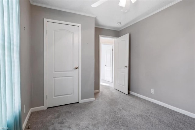 unfurnished bedroom featuring light carpet, ceiling fan, and crown molding