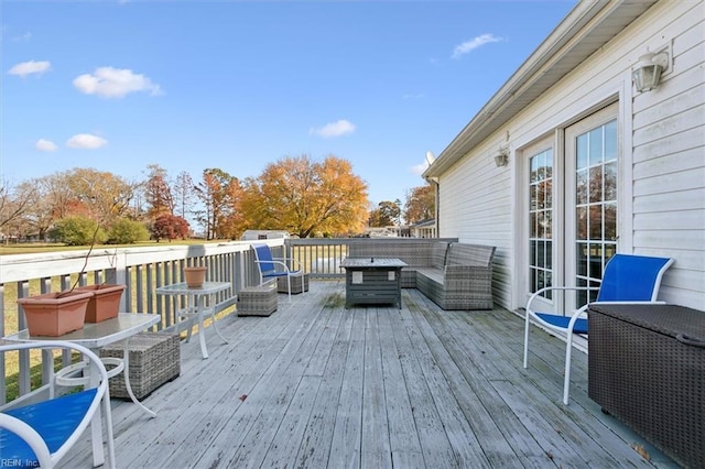 wooden terrace with an outdoor hangout area