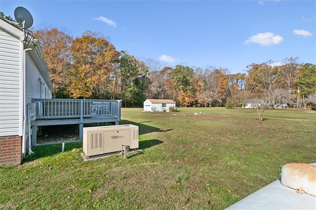 view of yard featuring a wooden deck and a storage unit