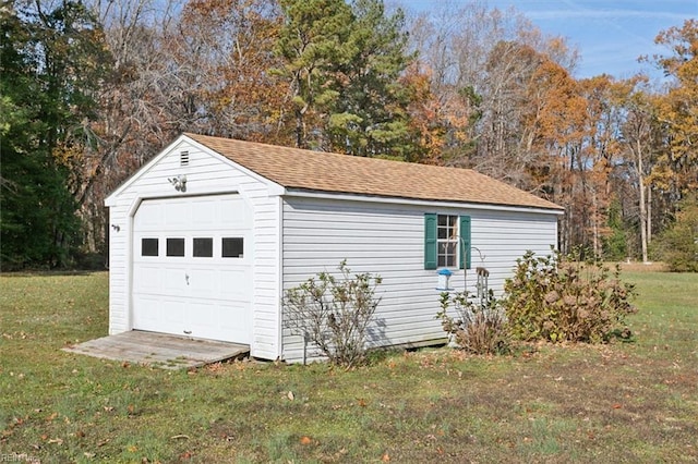 garage featuring a lawn