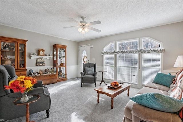 living room featuring a textured ceiling, light colored carpet, and ceiling fan