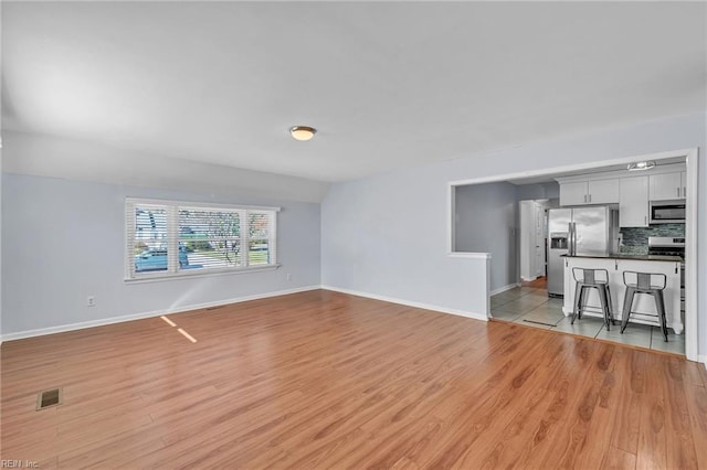 living room with light hardwood / wood-style flooring and lofted ceiling