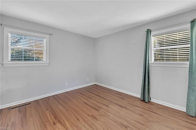 unfurnished room with light wood-type flooring