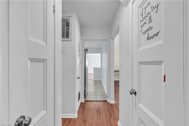 hall with light hardwood / wood-style flooring