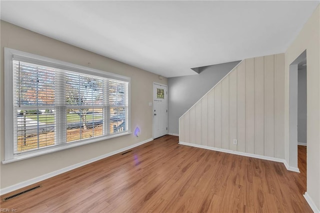 foyer entrance featuring light hardwood / wood-style flooring and a healthy amount of sunlight