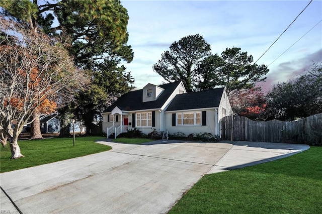 cape cod-style house with a front yard