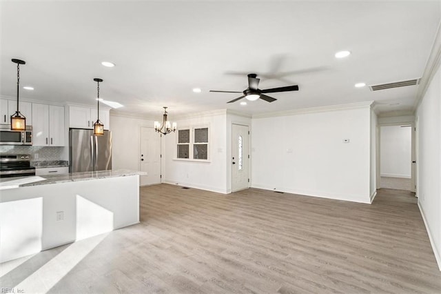 kitchen with light hardwood / wood-style flooring, backsplash, decorative light fixtures, white cabinets, and appliances with stainless steel finishes