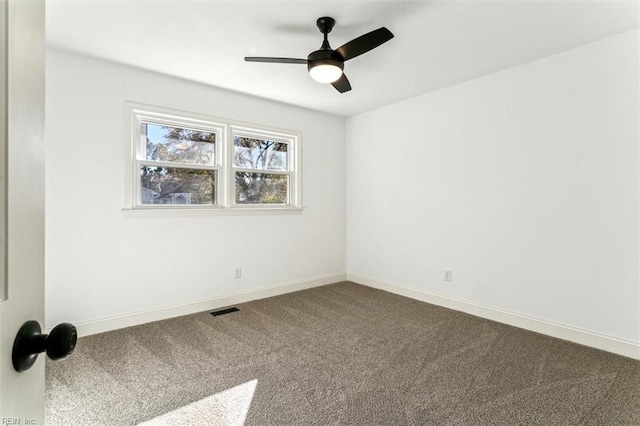 carpeted spare room with ceiling fan