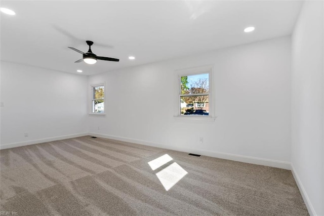 empty room with light carpet and ceiling fan