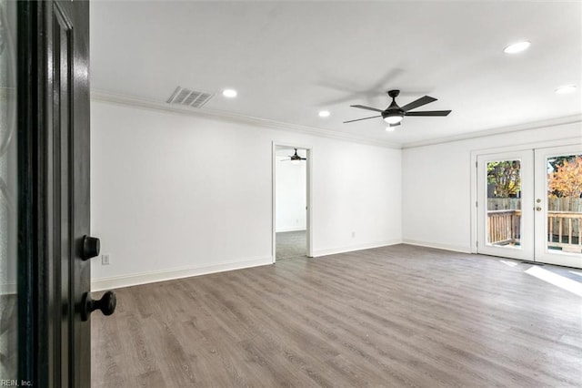 spare room with french doors, hardwood / wood-style flooring, ceiling fan, and ornamental molding