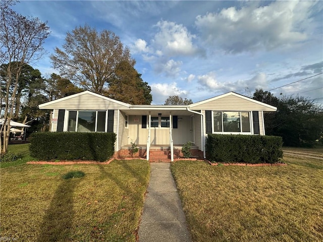 single story home with a porch and a front yard