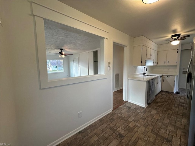 kitchen with white cabinetry, sink, ceiling fan, and stainless steel appliances