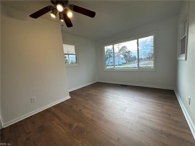 spare room featuring ceiling fan and dark hardwood / wood-style flooring